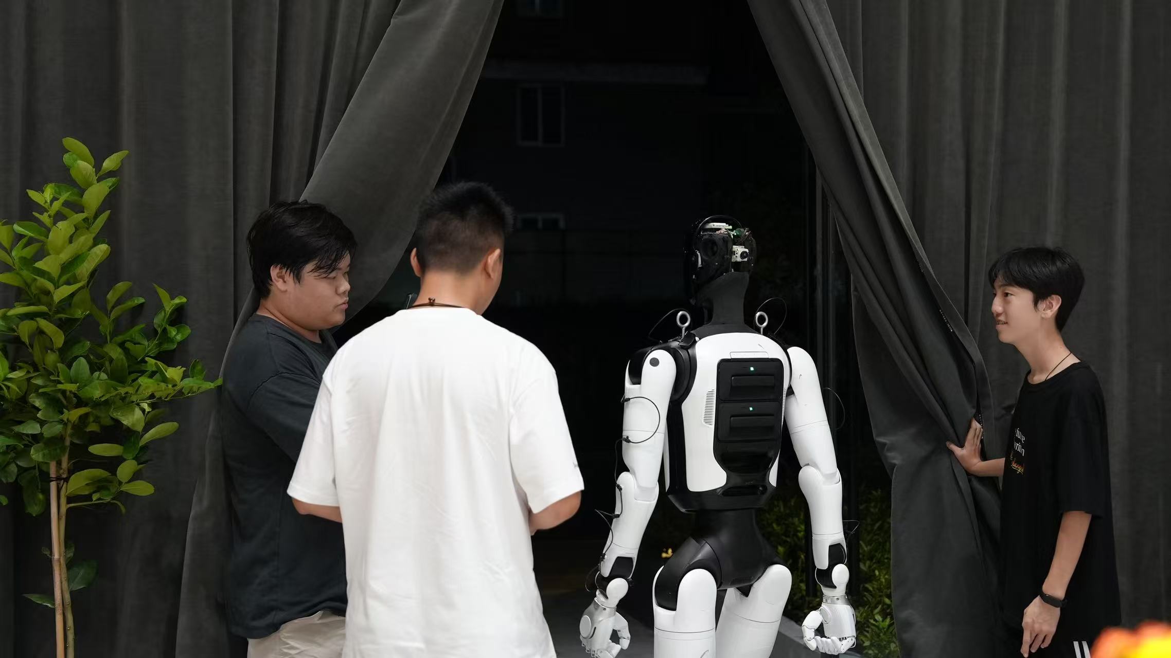 A group gathered around a humanoid robot