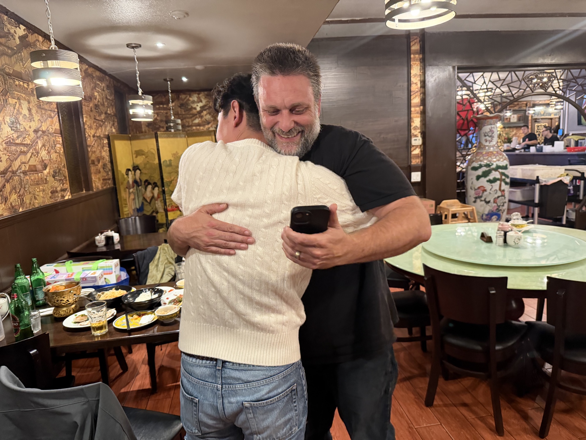 Two people sharing a hug after a meal