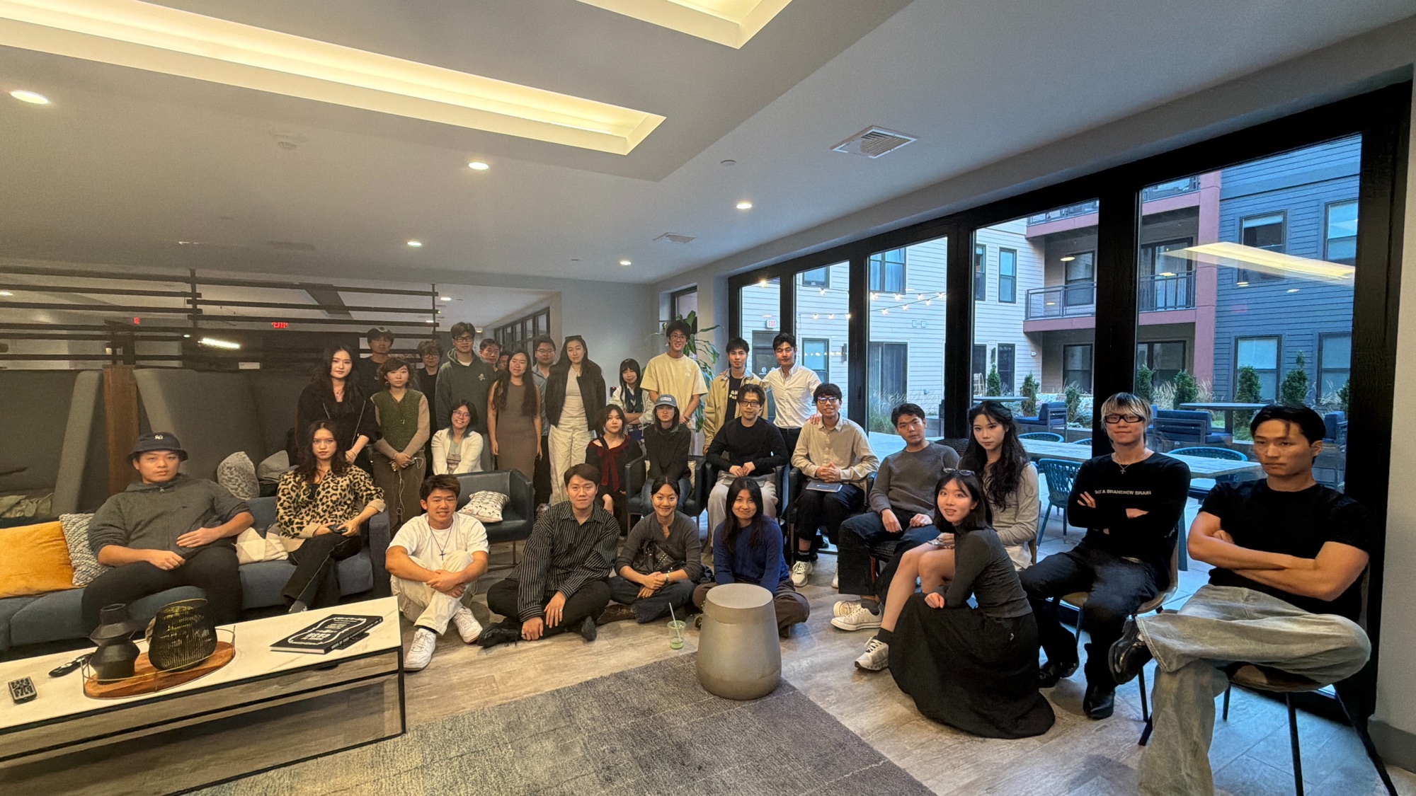 A large group gathered in a lounge
